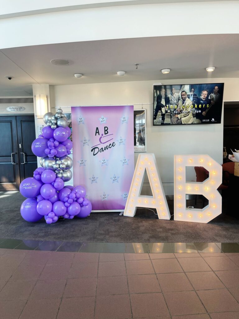 balloon decor, company banner and marquee letters