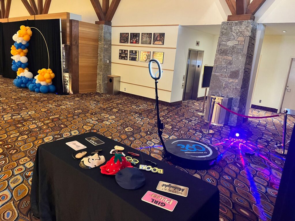 360 video booth with props and a balloon arch